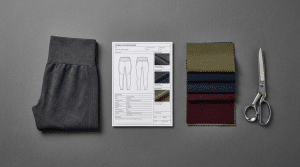Featured image for how to start a fitness clothing brand, showing the process from tech pack and fabric selection to the final manufactured leggings.
