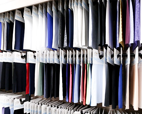 Extensive library of high-performance activewear fabric swatches (Nylon, Spandex, Recycled Blends) available for client selection at Maes Group showroom.