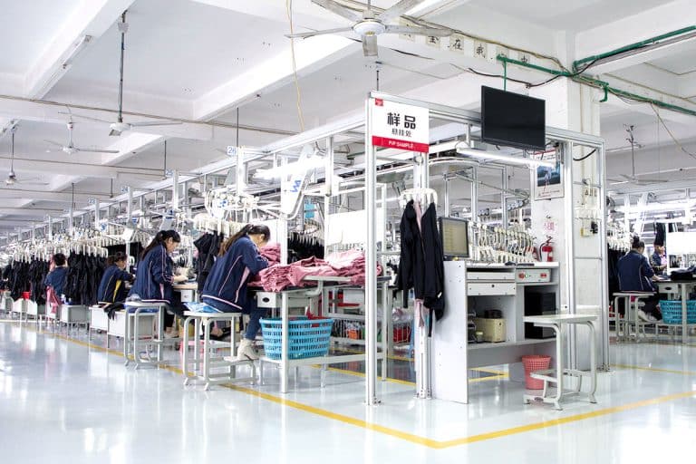 Systematic activewear production unit featuring a dedicated P/P sample station and automated garment hanging systems for precise sportswear manufacturing.
