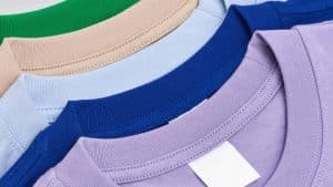 Close-up of premium heavyweight cotton custom oversized t-shirts featuring high-density ribbed collars in standard colors including Green, L.Blue, and L.Purple.