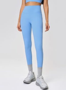 Close up of 70/30 nylon spandex pants featuring 3D silicon logo and reinforced contour stitching for B2B wholesale.