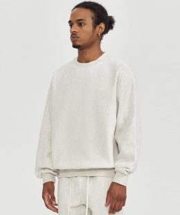 Detail of a heavyweight crewneck sweatshirt's unique adjustable hem, featuring an extra-thick woven rope drawstring for a custom silhouette.
