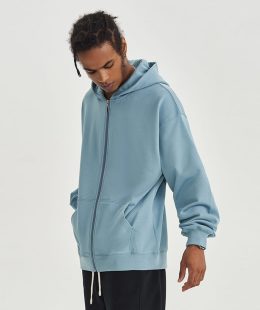 Close-up detail of the zipper garage (chin guard) on a men's slim fit zip up hoodie, a premium feature for added comfort and quality.